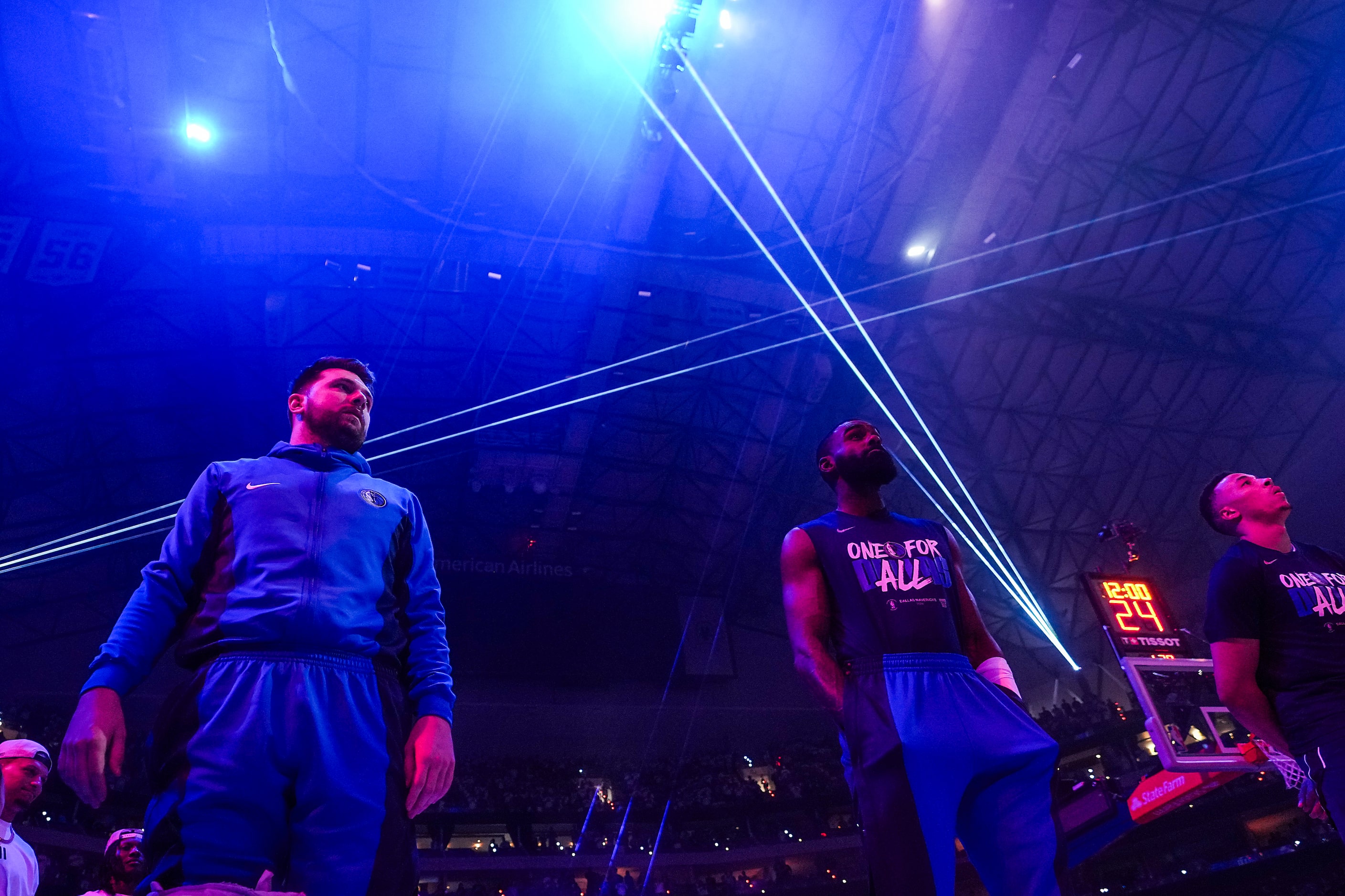 Dallas Mavericks guard Luka Doncic (left) stands for the national anthem before the first...