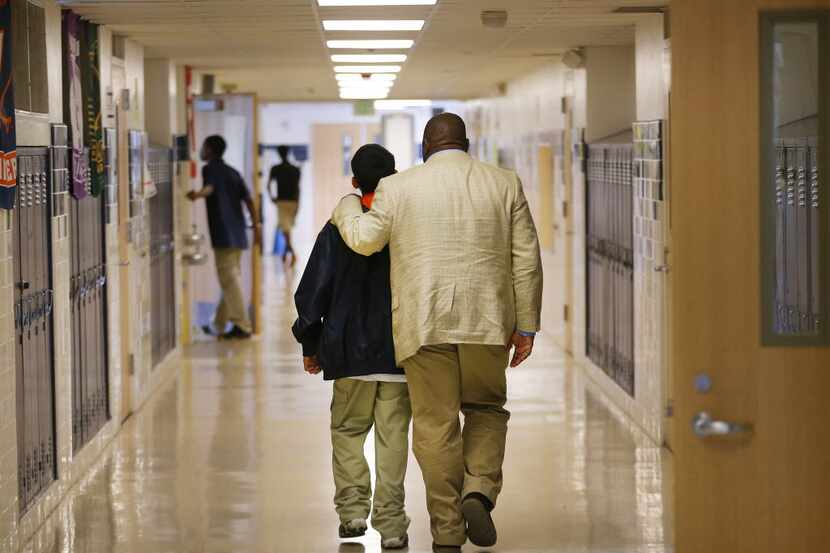 Jonathan Smith walks a student to his office as he makes the rounds during the first year as...