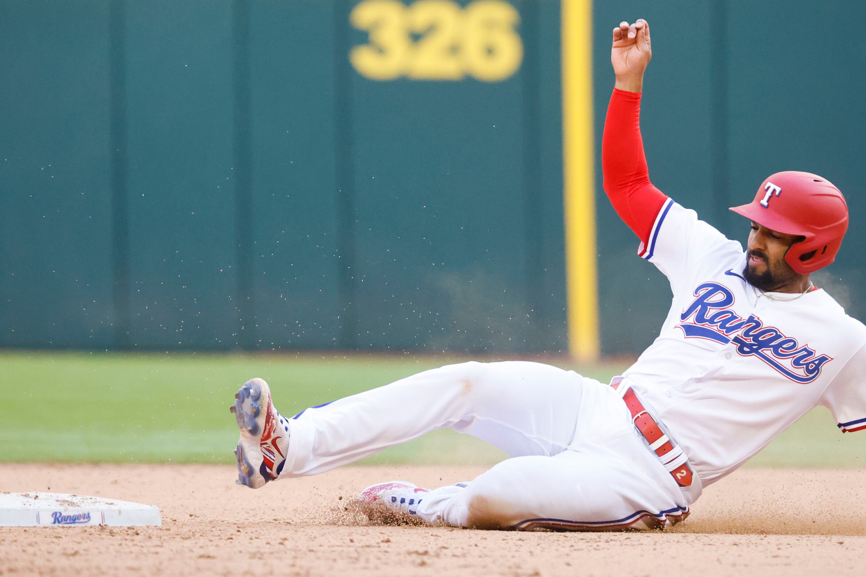Texas Rangers second baseman Marcus Semien reaches second base after shortstop Corey Seager...