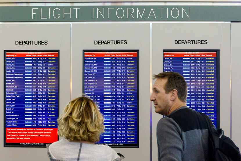 A departure board shows cancellation flights of Southwest Airlines at Chicago Midway...