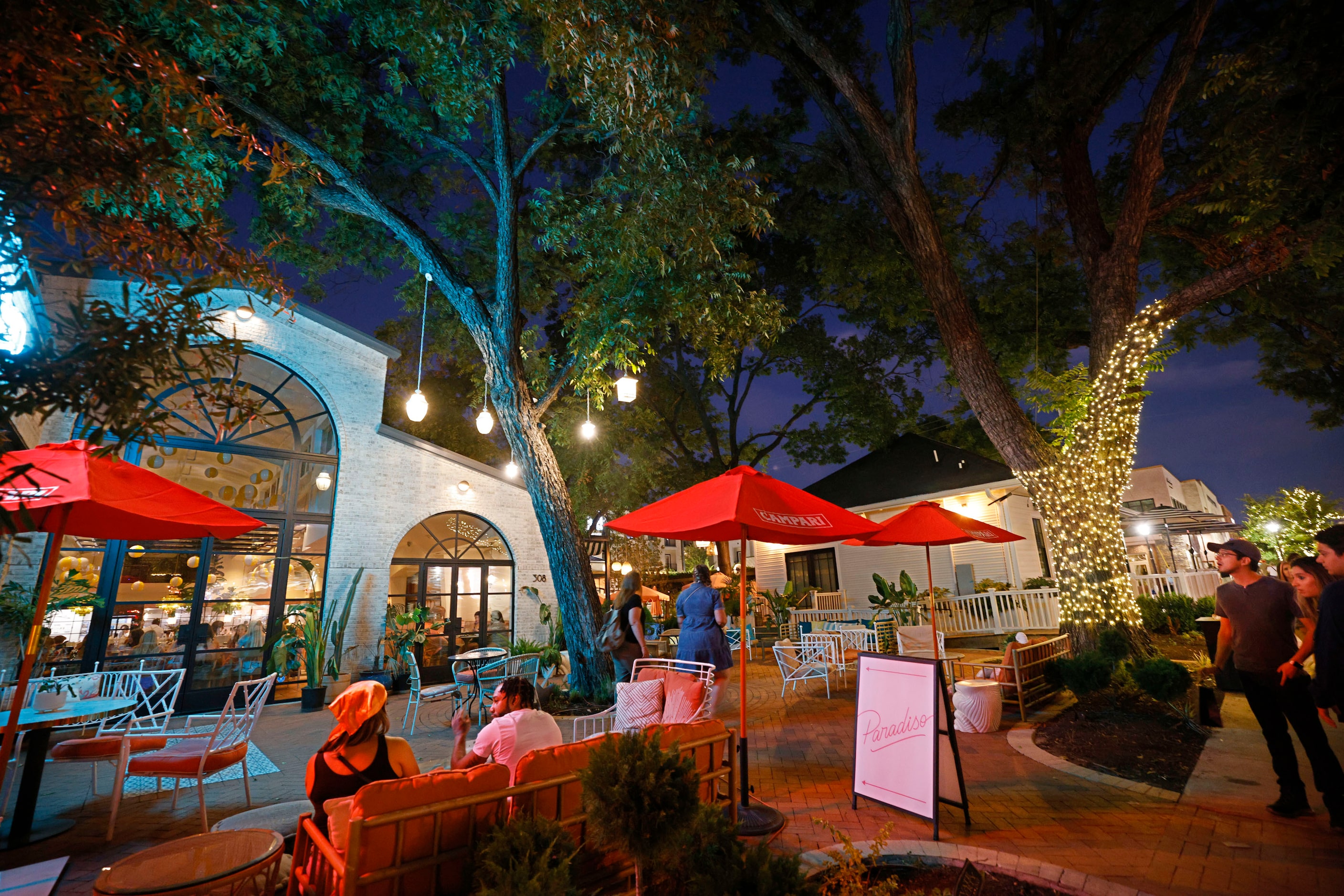 People sit on the patio at Paradiso in the Bishop Arts District in Dallas, Saturday, Sept....