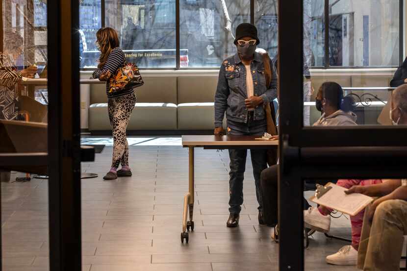 Registrants wait at the DeSoto Public Library for a COVID-19 vaccination registration drive...