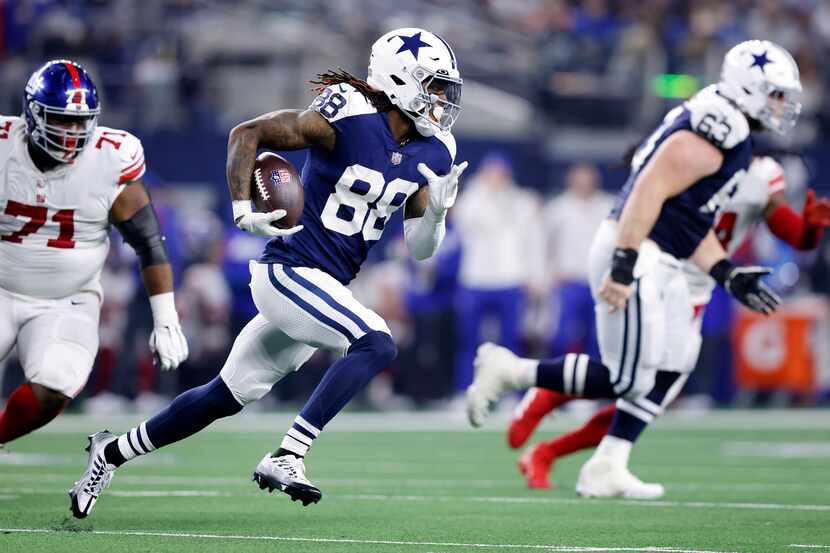 Dallas Cowboys wide receiver CeeDee Lamb (88) races around the end after taking a fourth...