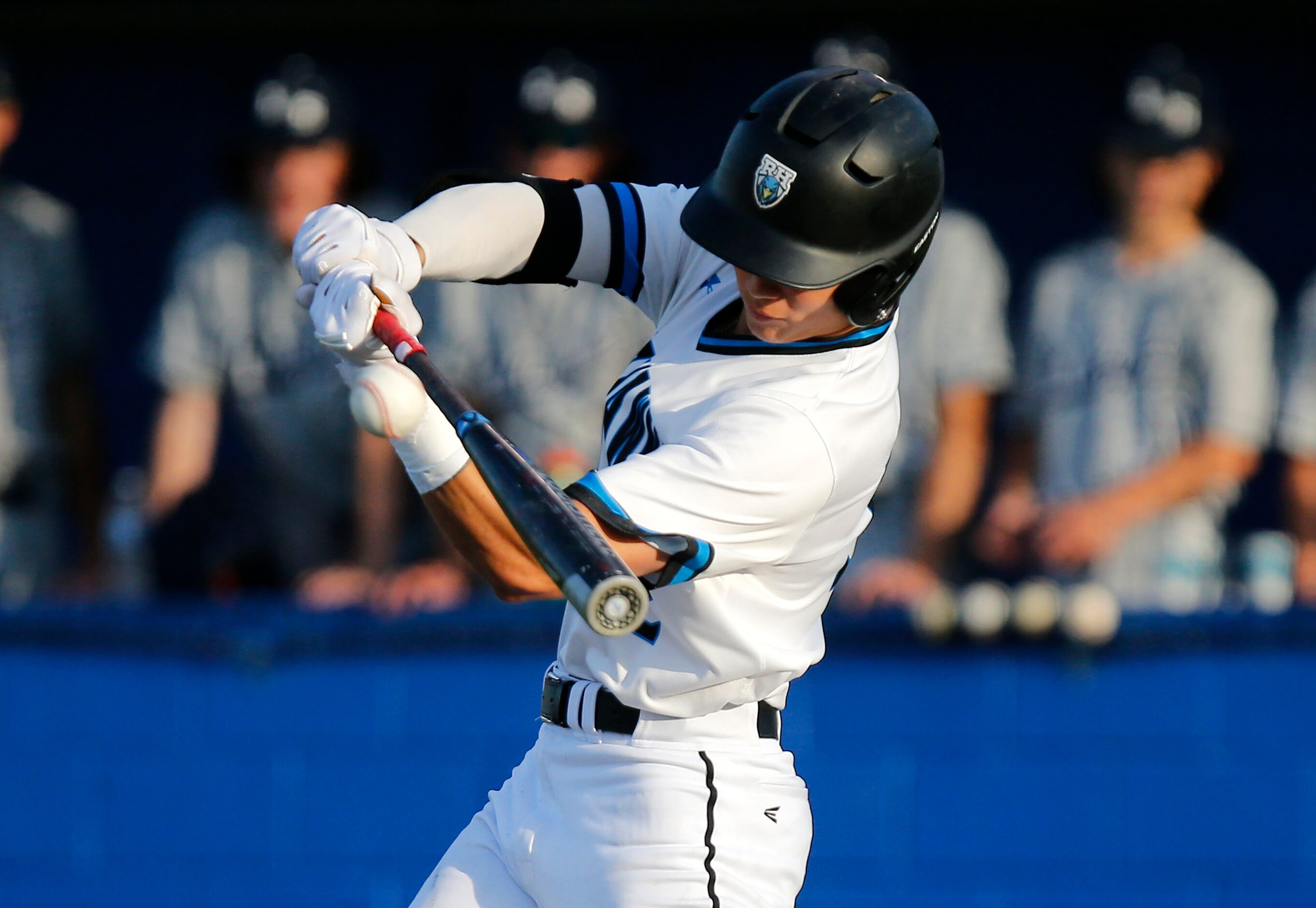 Rock Hill High School center fielder Brenner Cox (32) makes contact in the first inning as...