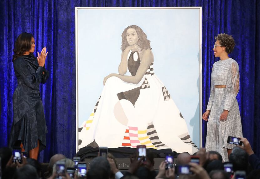 Former U.S. first lady Michelle Obama (L) and artist Amy Sherald unveil her portrait during...