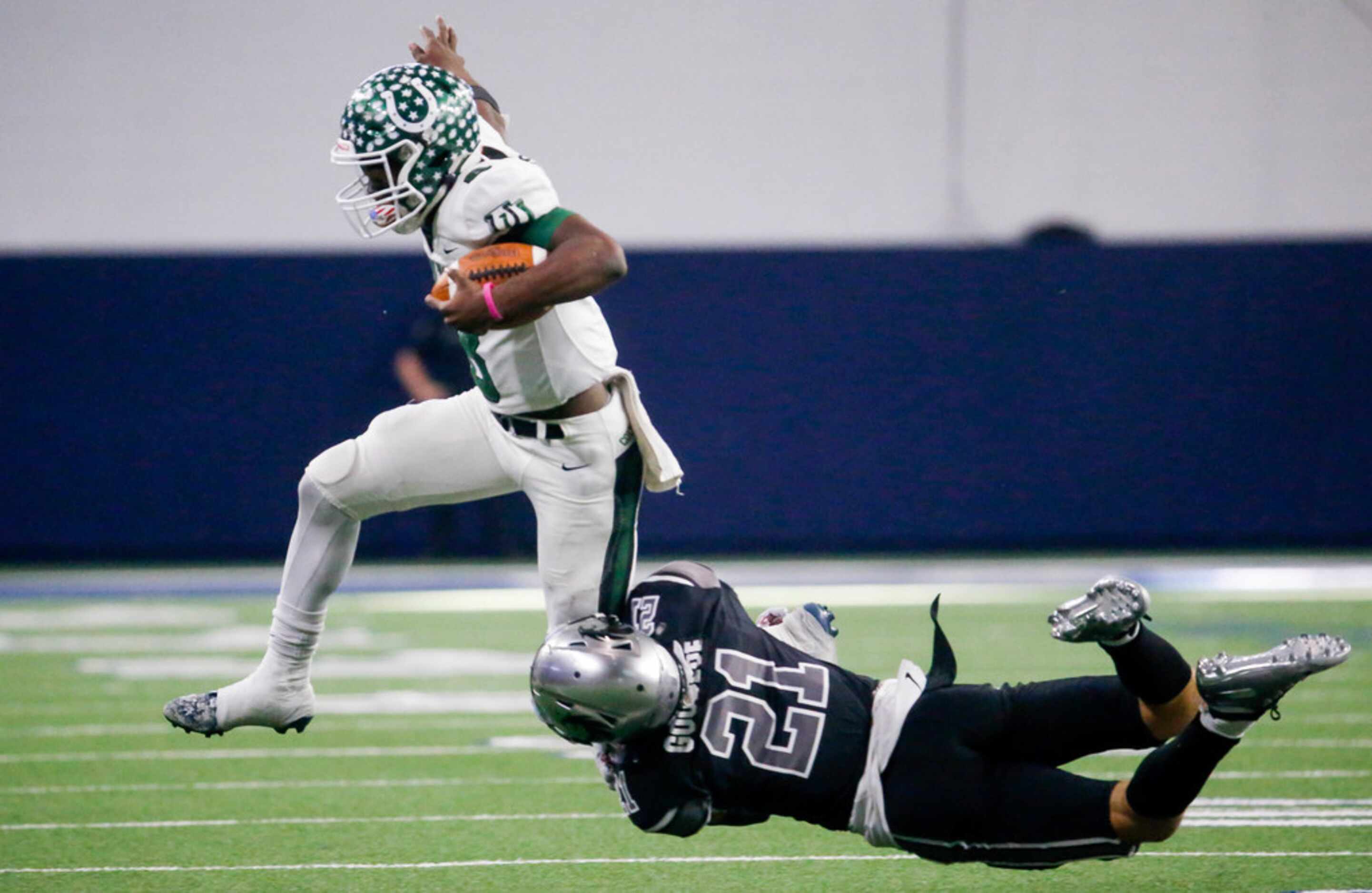 Arlington's quarterback Kris Sims (8) is tackled by GuyerÃs defensive back Darious Goodloe...