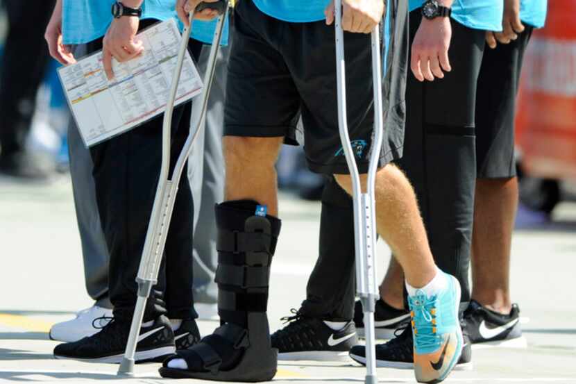 Carolina Panthers' Greg Olsen stands on crutches in the second half of an NFL football game...