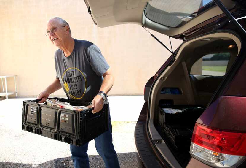 Volunteer Duane Landa unloads a delivery of donated goods from Tom Thumb at the NTX...