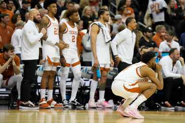 Texas watches during their loss against Miami in an Elite 8 college basketball game in the...