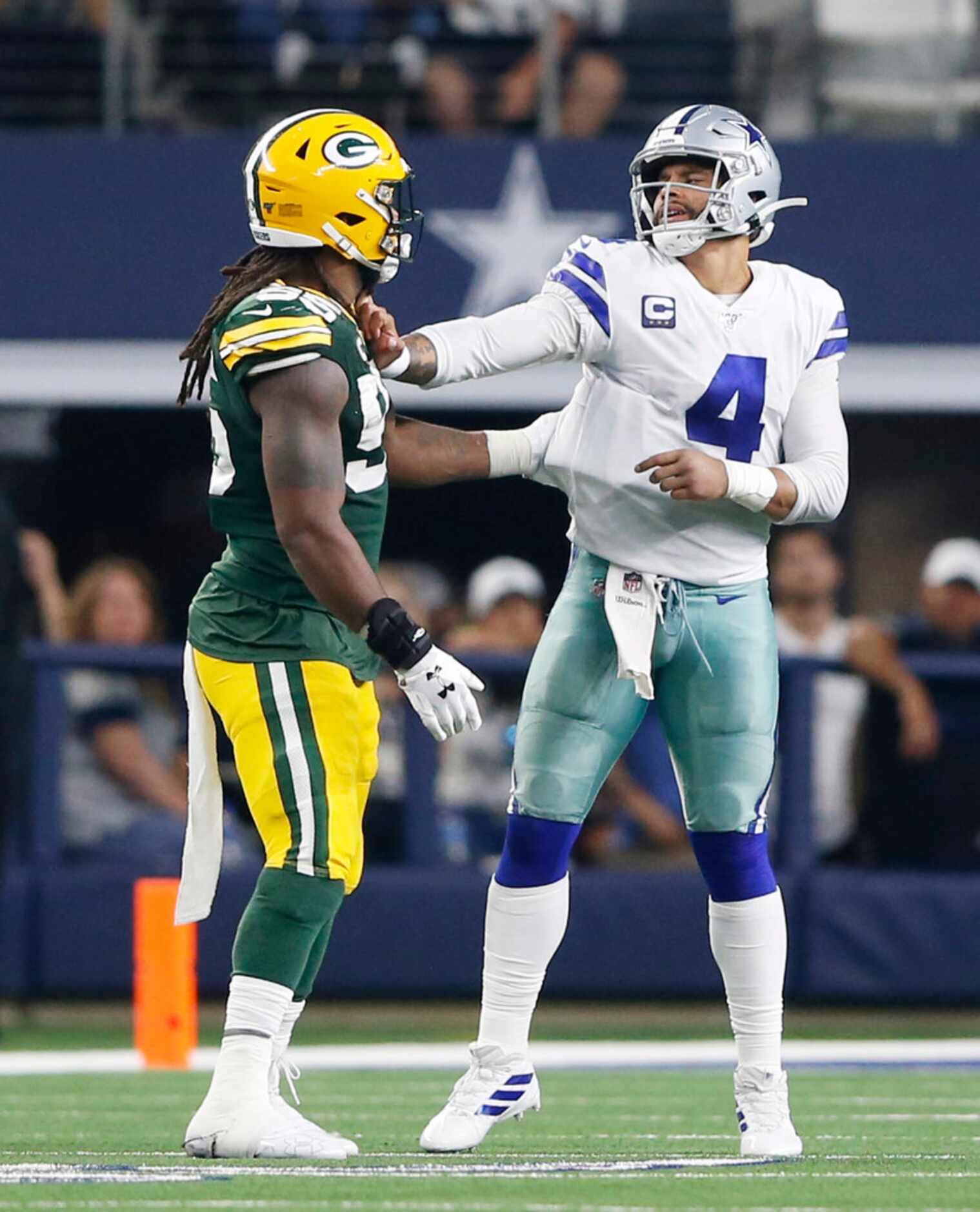 Dallas Cowboys quarterback Dak Prescott (4) pushes Green Bay Packers outside linebacker...