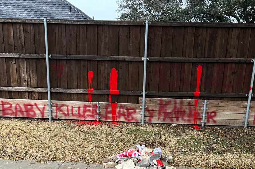 Graffiti and a pile intended to symbolize dead babies at the home of Dallas council member...