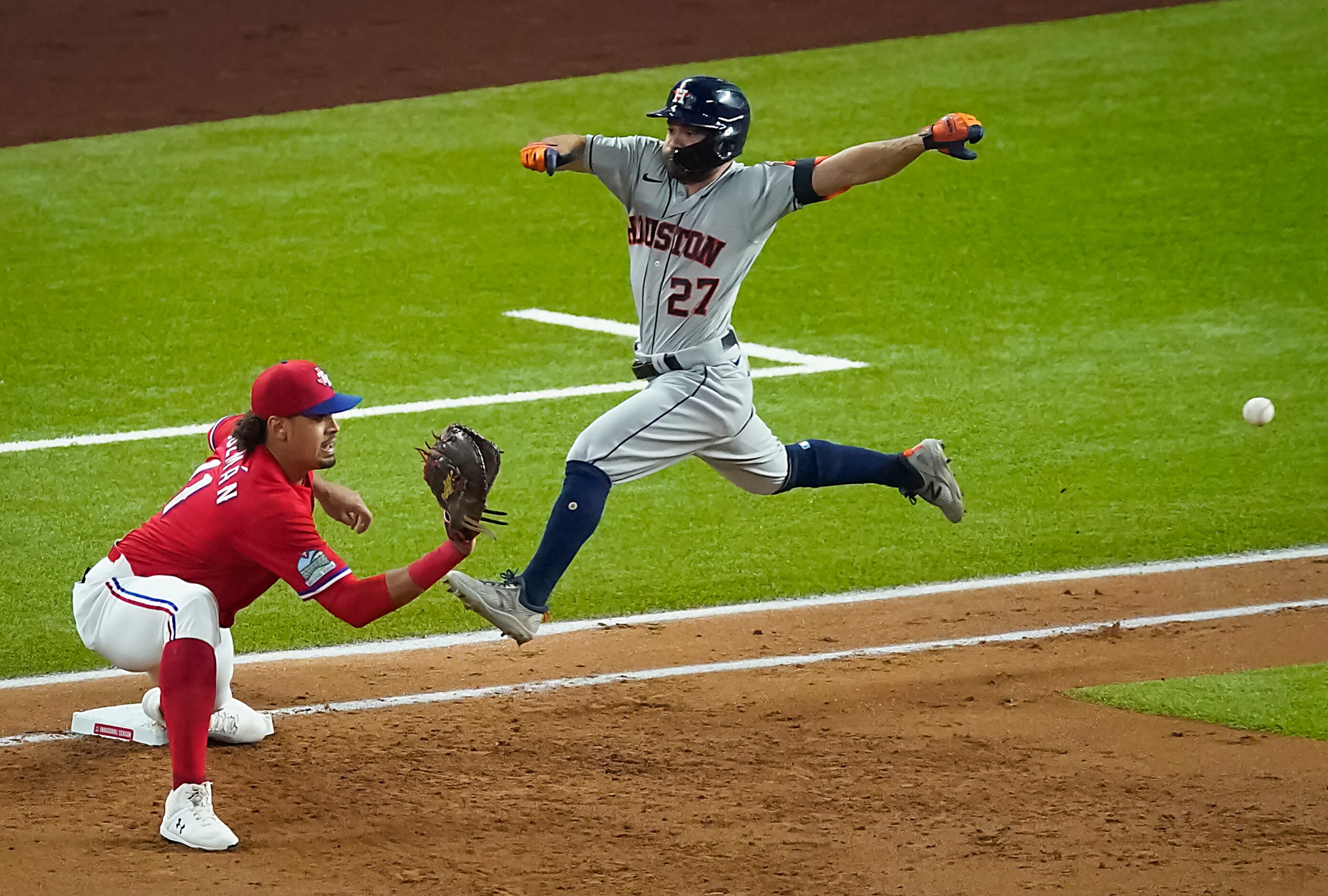 Texas Rangers first baseman Ronald Guzman takes the throw from third baseman Derek Dietrich...