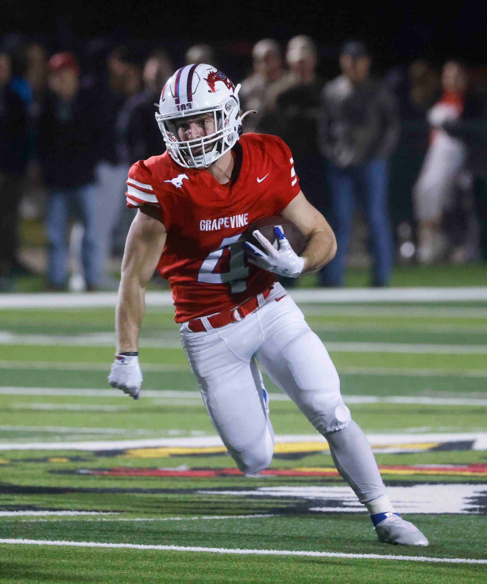 Grapevine high’s Parker Polk (4) runs for a yardage against Argyle High during the first...