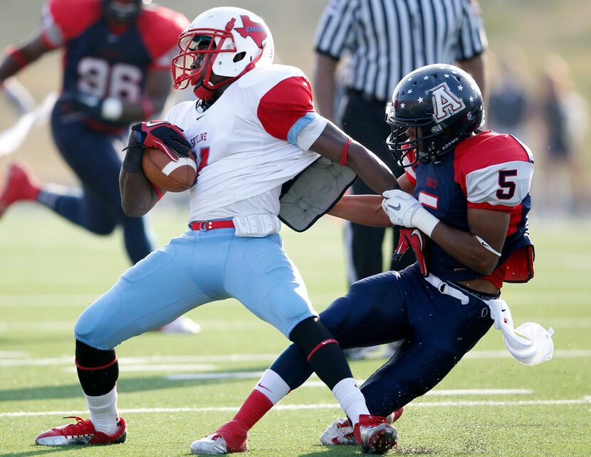 Skyline's Emmanuel Harris (11) attempts to break away from Allen's Chad Adams (5) during the...