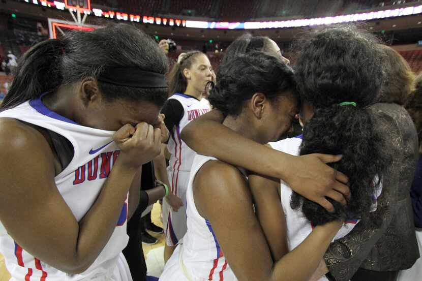 Duncanville Pantherettes work to console each other after their loss to Manvel. The two...