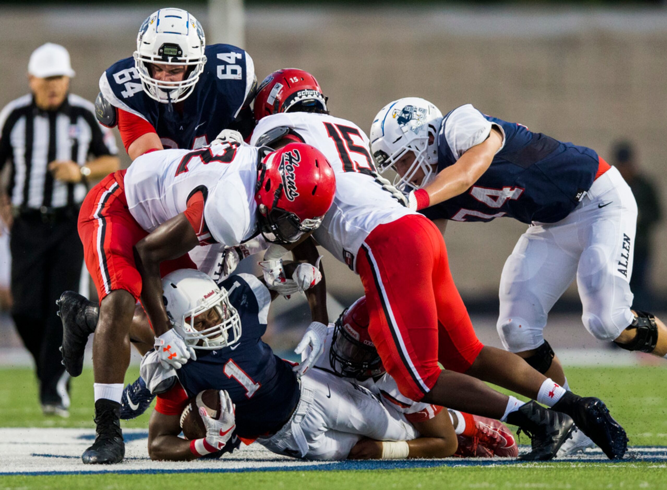 Allen running back Celdon Manning (1) is taken down by Cedar Hill defenders during the...