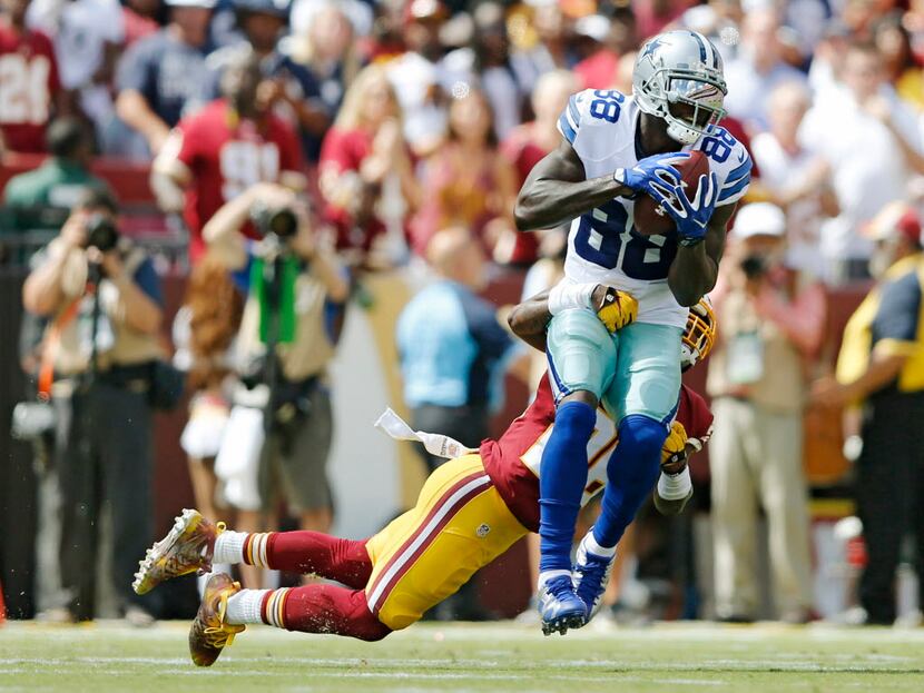 Dallas Cowboys wide receiver Dez Bryant (88) is tackled by Washington Redskins cornerback...