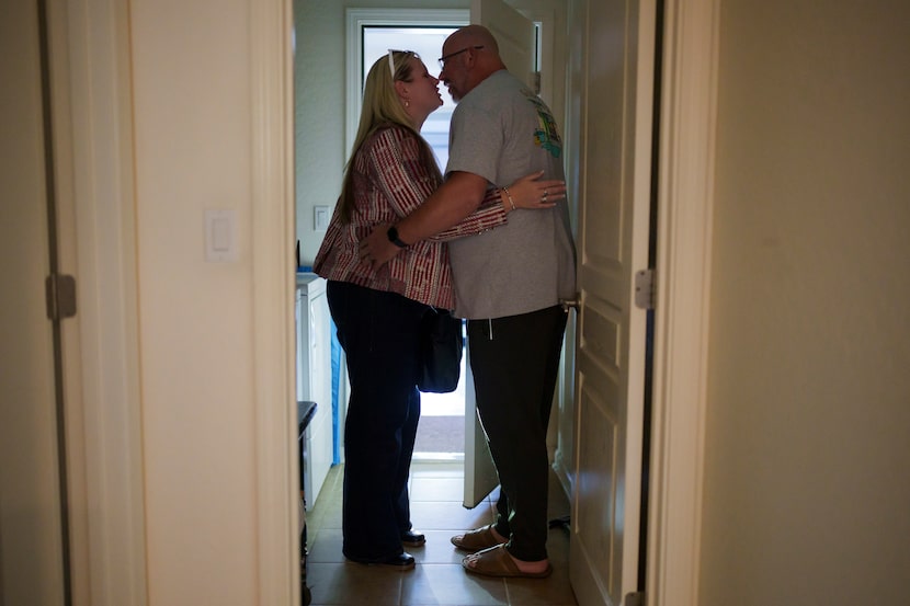 Cari-Ann Burgess, interim Registrar of Voters for Washoe County, Nev., left, kisses husband...