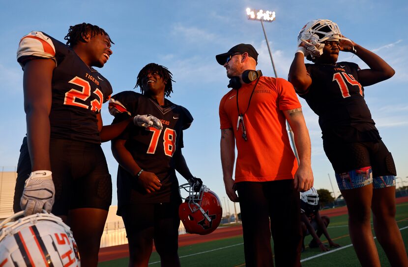 Penrod (second from right) visits with players (from left) Joshua Callicutt, Alton...