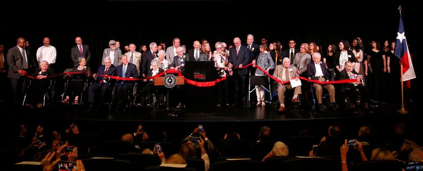 A host of dignitaries join museum staff and Holocaust survivors onstage for the...