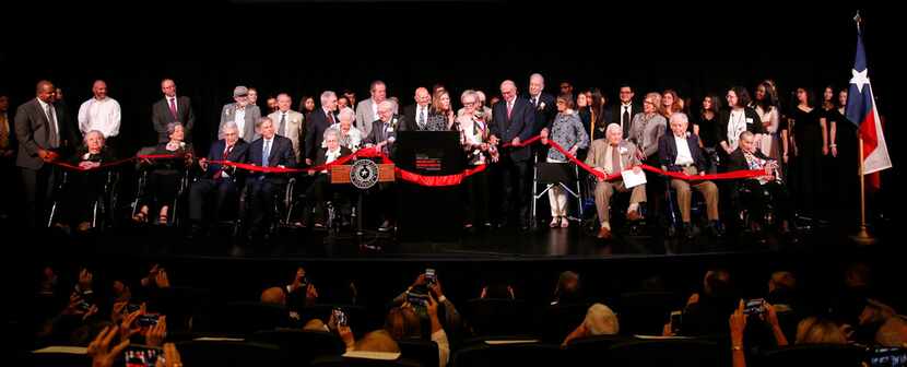 A host of dignitaries join museum staff and Holocaust survivors onstage for the...