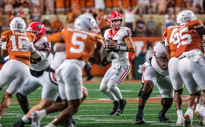 Georgia quarterback Carson Beck (15) looks down field for a receiver against Texas during...