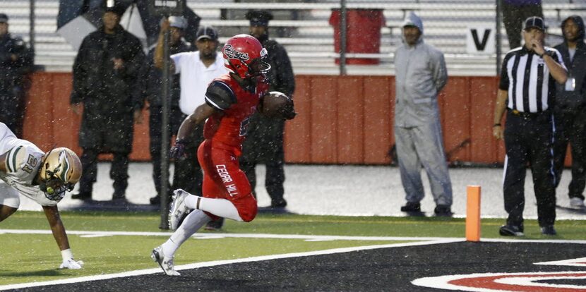 Cedar Hill's Jameel Moore (5) rushes into the end zone for a touchdown in a game against...