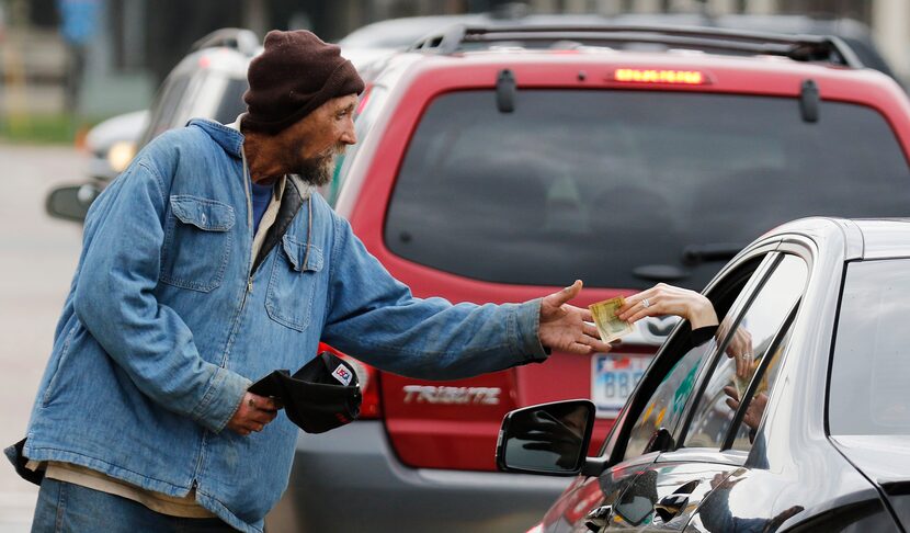 Robert Rushing, 58, works the corner on the service road of I-35 and Oaklawn on Monday,...