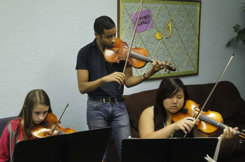 Marcus Pyle, left, a 23-year-old Juilliard student from Garland, teaches a class at his...