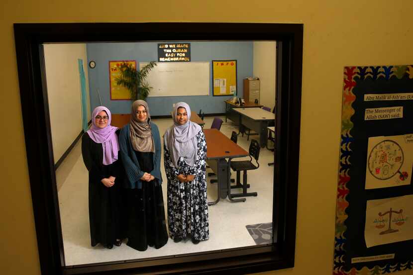 Viewed through a window, student Iman Ikram (from left), principal Fawzia Belal and student...