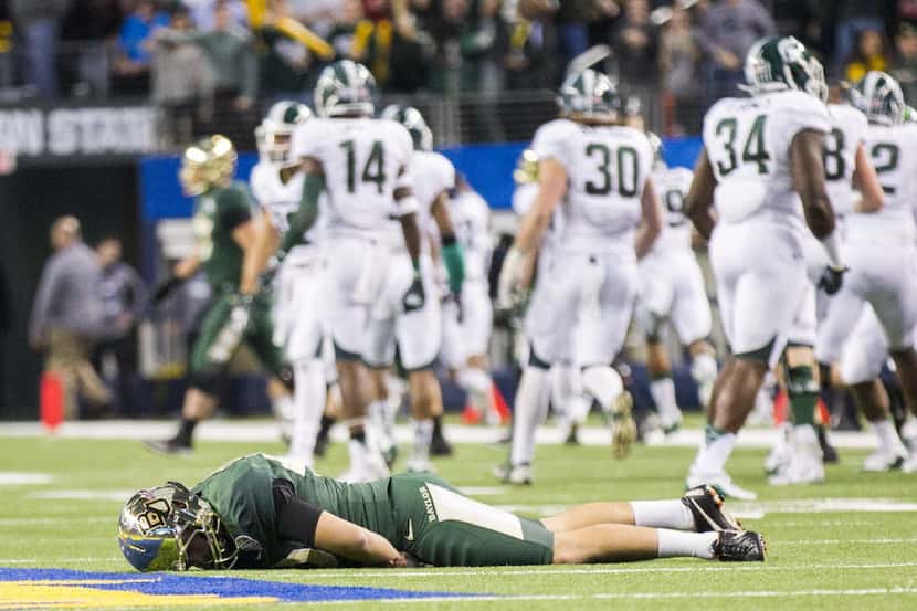Baylor Bears place kicker Chris Callahan (40) lays on the field disappointed after the...