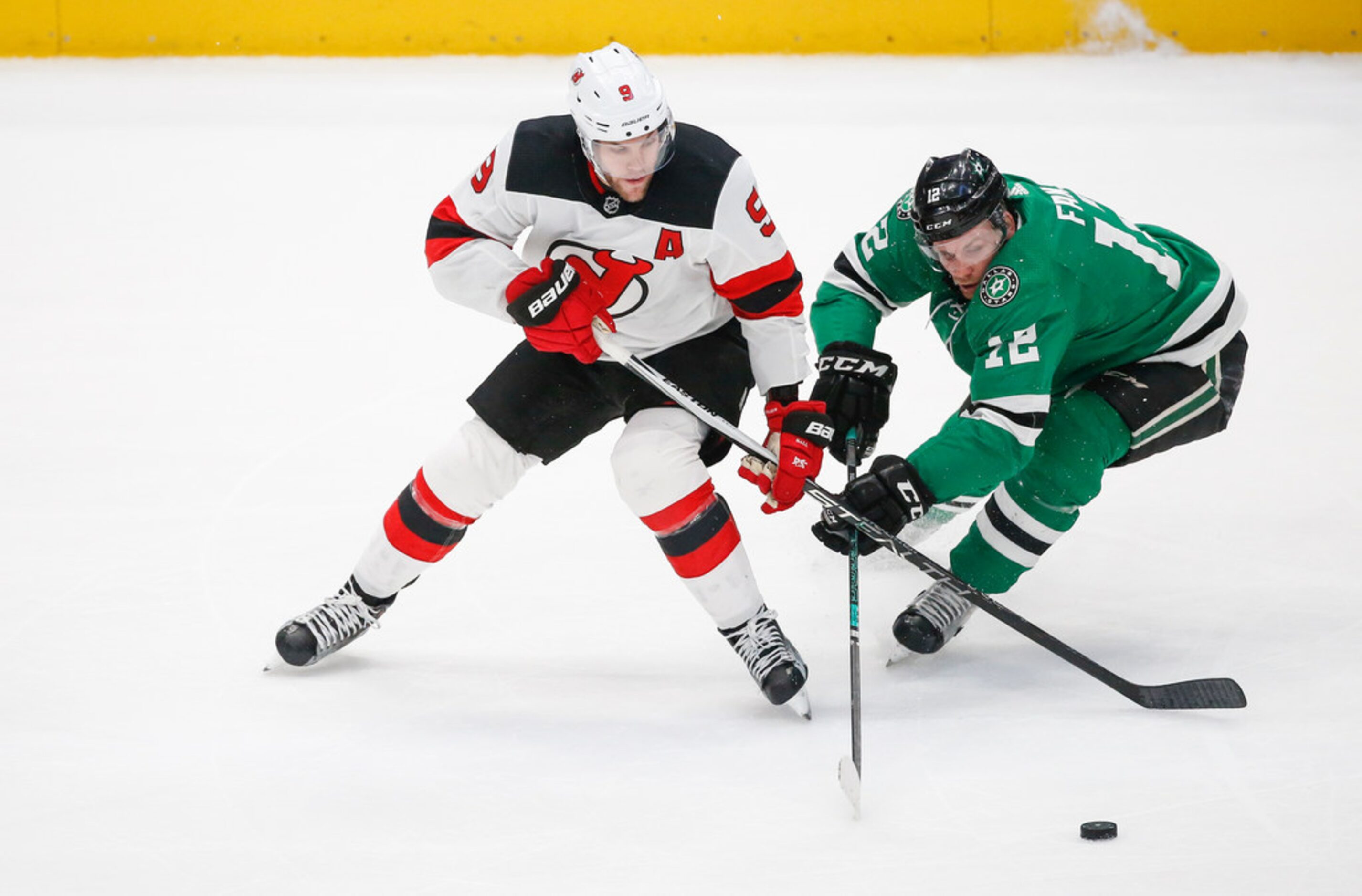 Dallas Stars center Radek Faksa (12) and New Jersey Devils left wing Taylor Hall (9) battle...