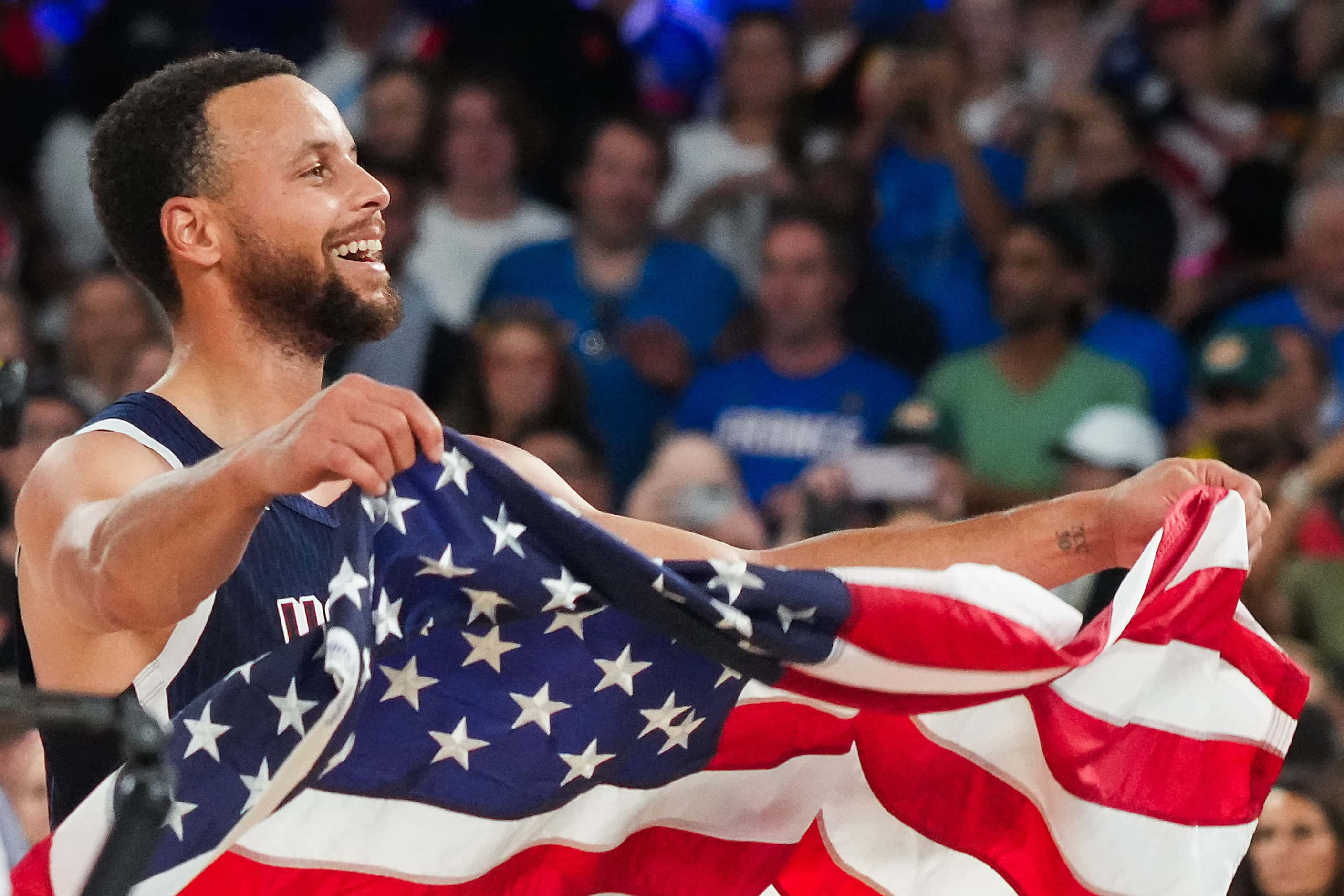 Stephen Curry of the United States celebrates after a victory over France in the men's gold...