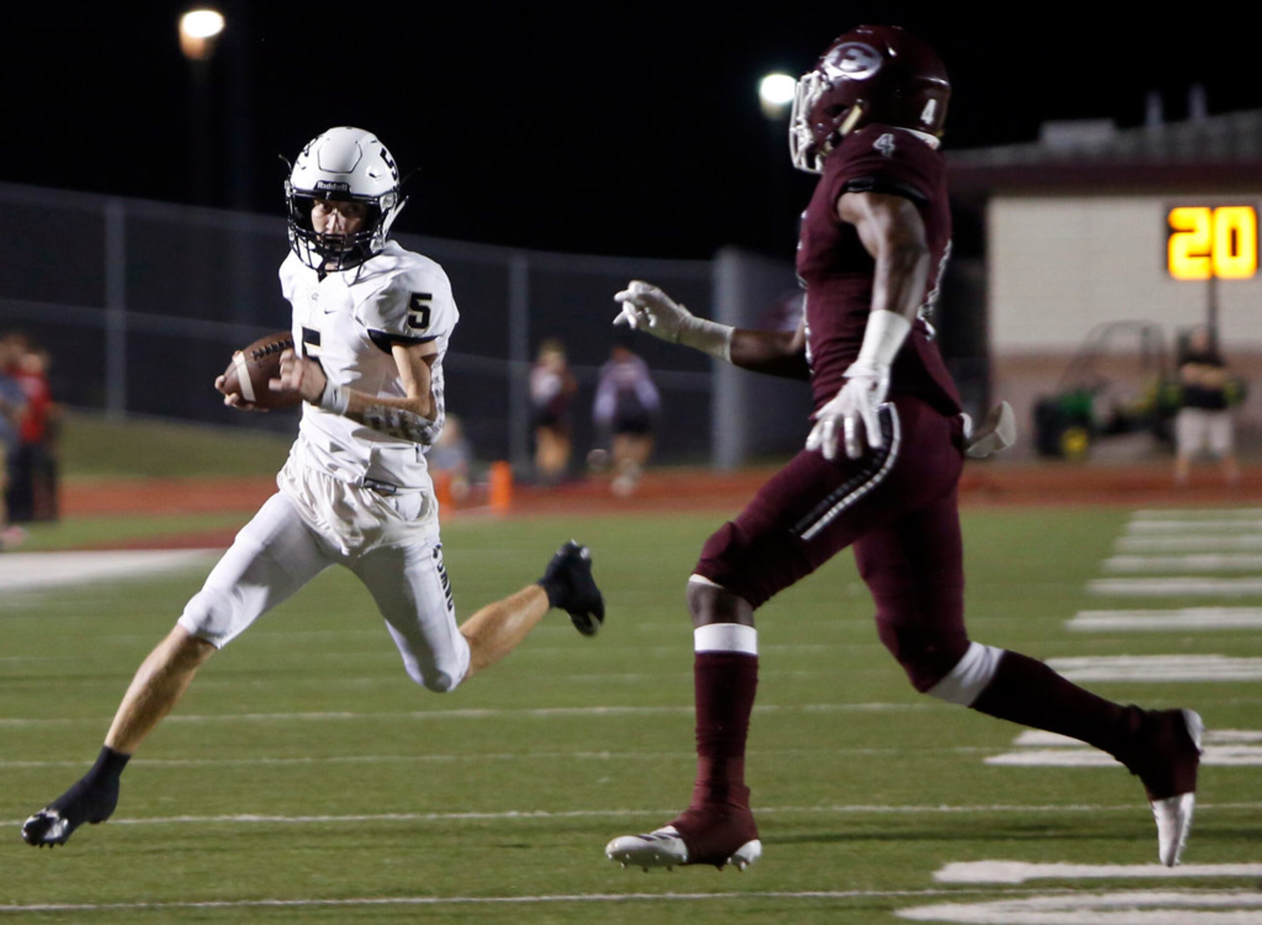 Royse City quarterback Tyson Oliver (5) rushes for a first down on a quarterback keeper as...