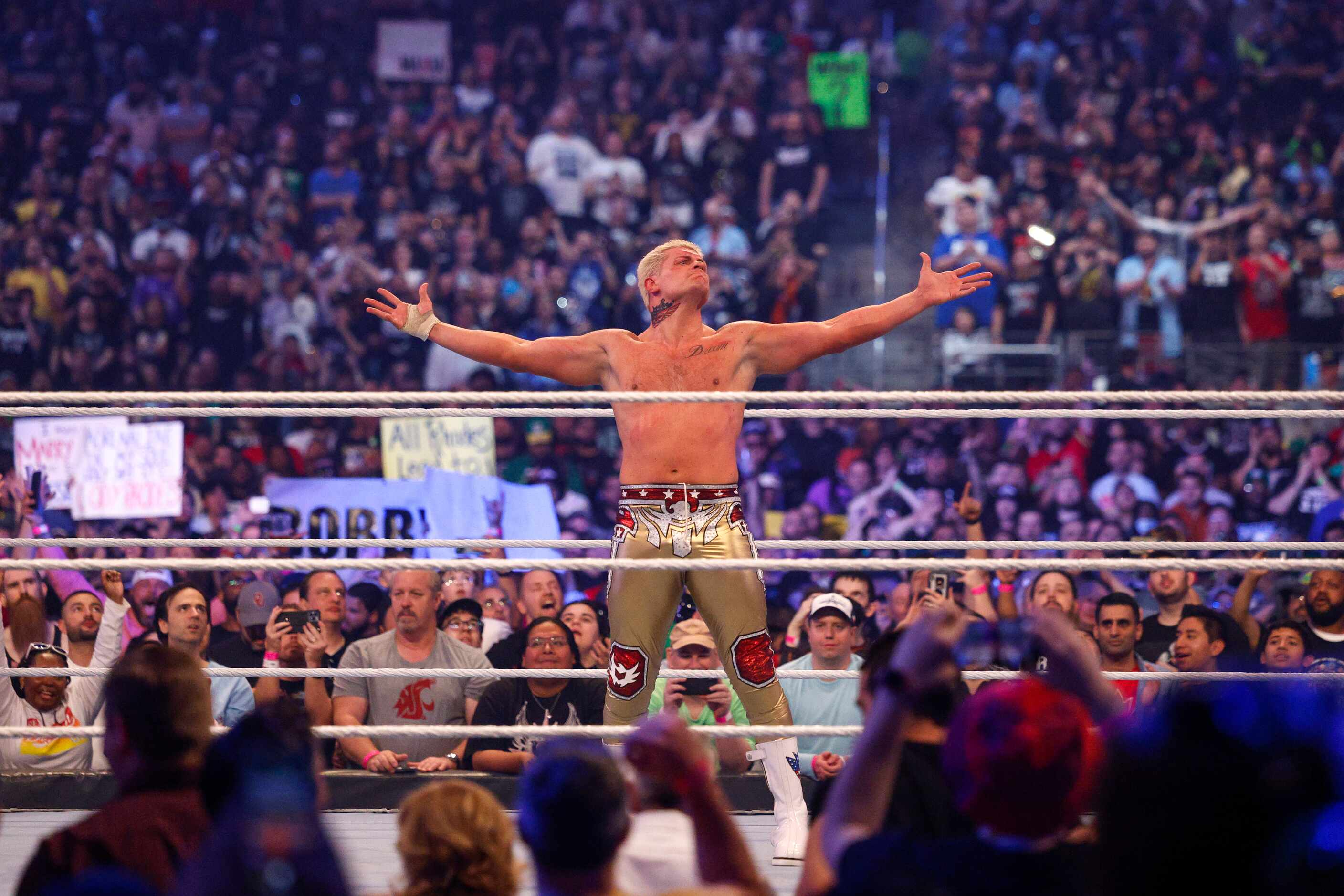 Cody Rhodes celebrates after defeating Seth Rollins during a match at WrestleMania 38 at...