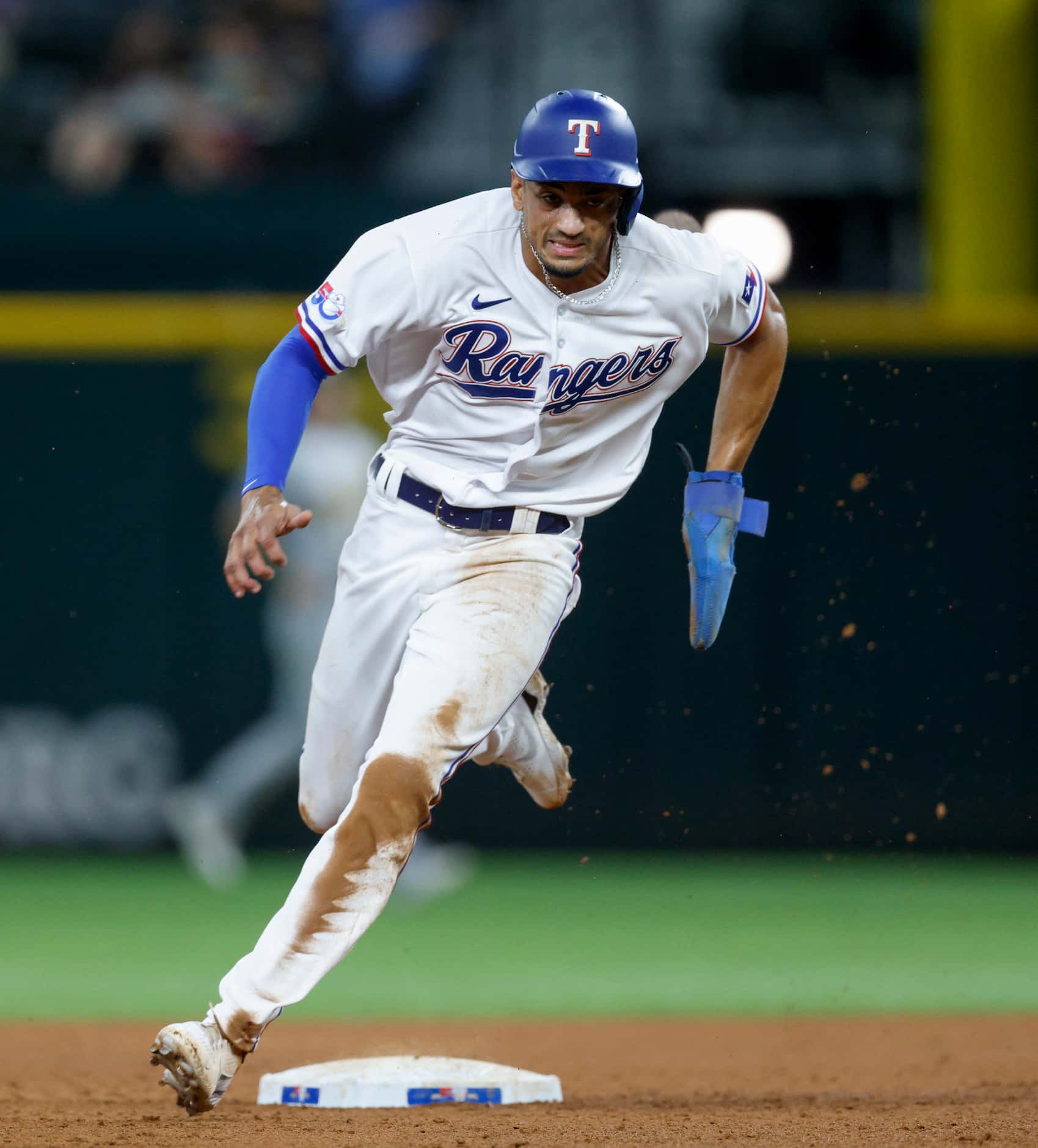 Texas Rangers left fielder Bubba Thompson (65) has to third base after a pickoff error by...