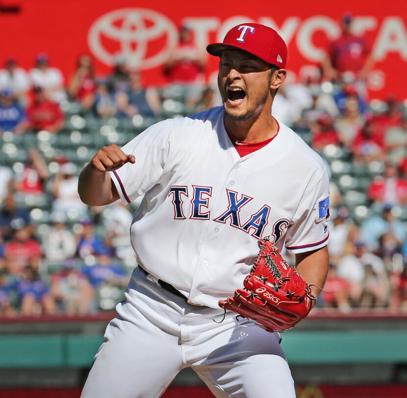 Texas Rangers starting pitcher Yu Darvish (11) reacts to Kansas City Royals second baseman...