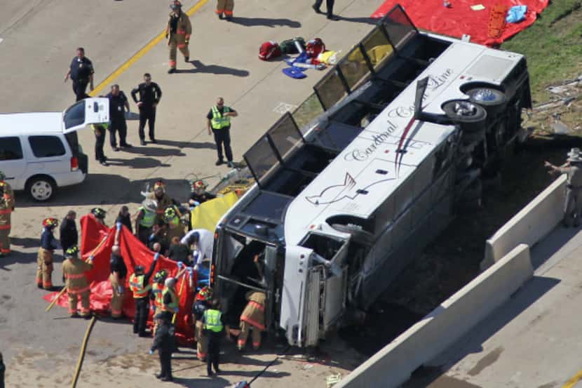 Rescue personnel work the scene where a charter bus carrying passengers to an Oklahoma...