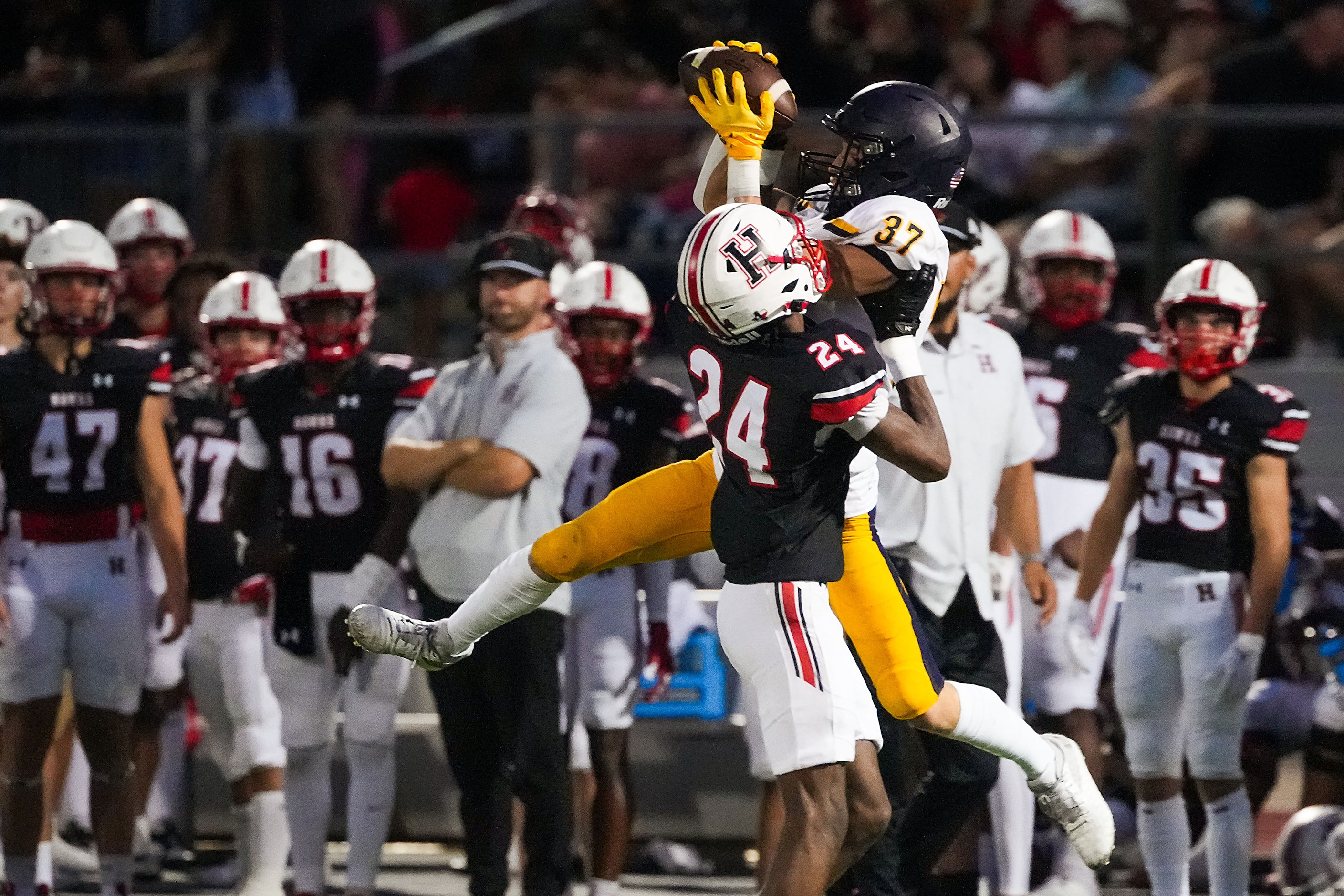 Highland Park wide receiver Cannon Bozman (37) catches a pass over Rockwall-Heath defensive...