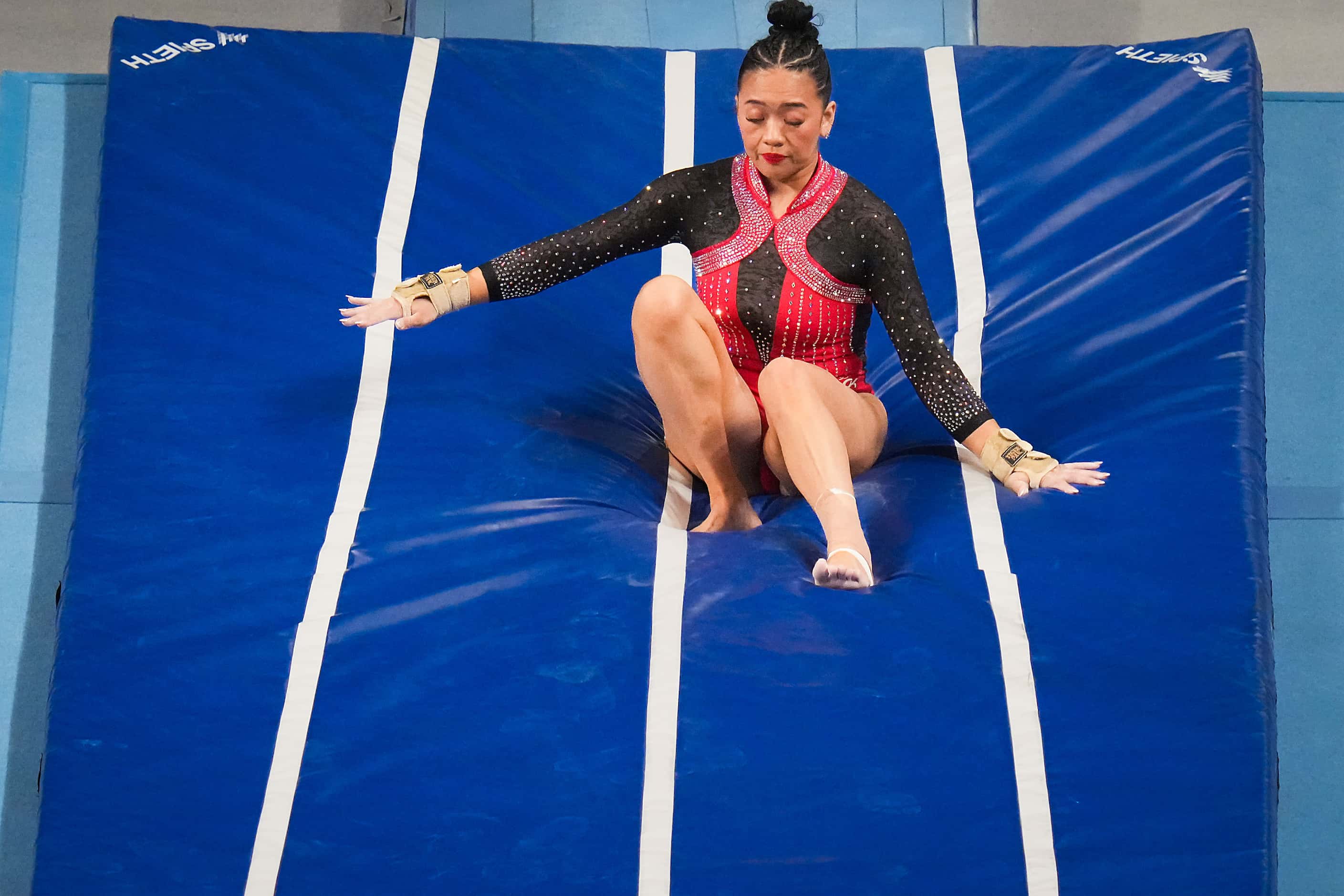 Sunisa Lee sits on the landing as she competes on the vault during the U.S. Gymnastics...