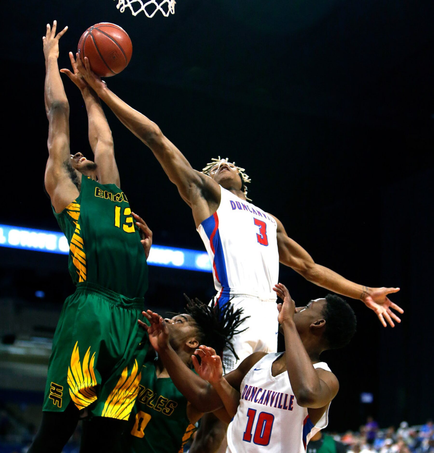 Oak Cliff Faith Academy's Rakeim Gary #3 reaches for a rebound with Klein Forest's Calvin...