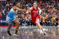 Indiana Fever guard Caitlin Clark (22) makes a move around the defense of Chicago Sky guard...