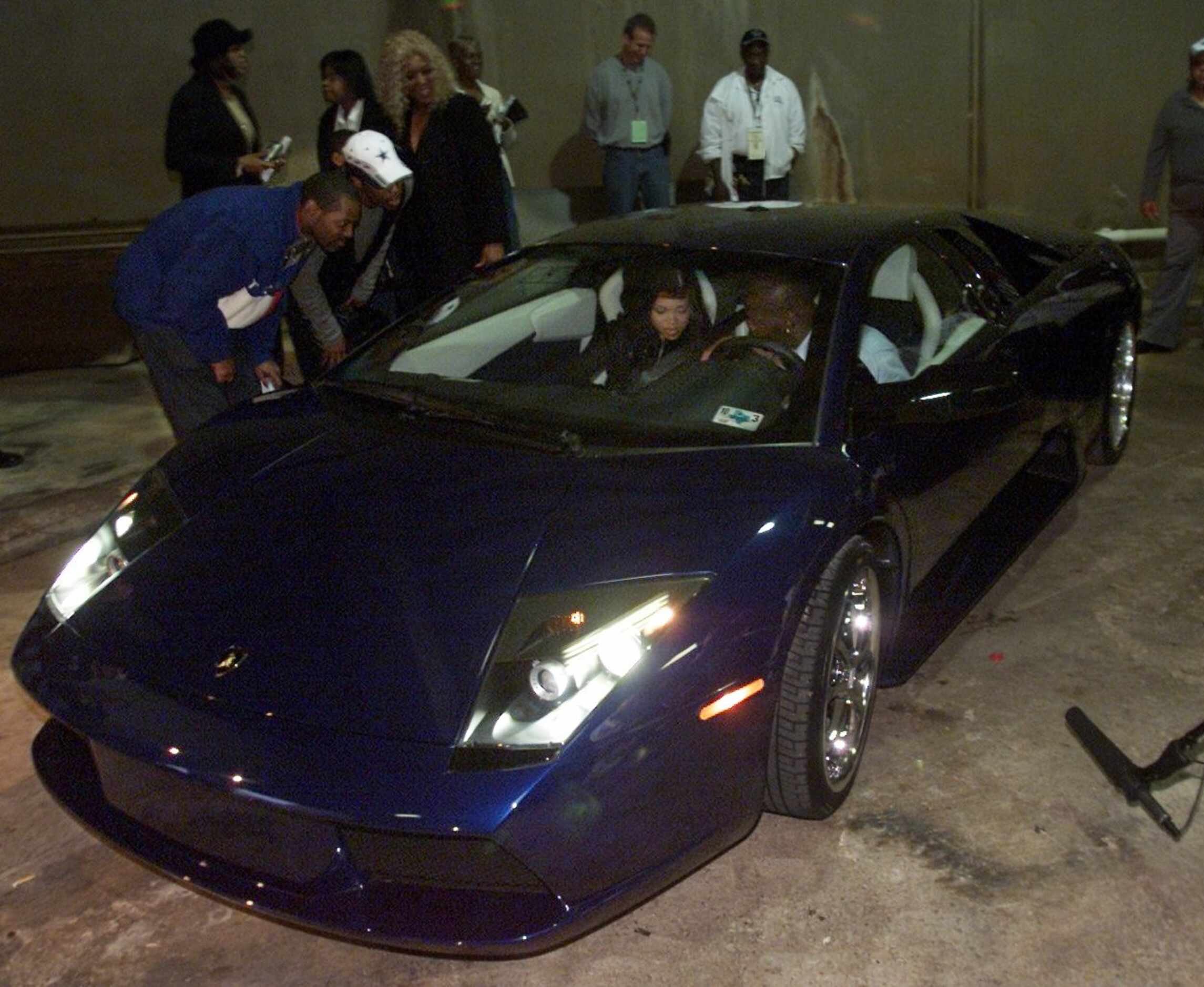 Dallas Cowboys running back Emmitt Smith and his wife, Pat Lawrence, depart Texas Stadium in...