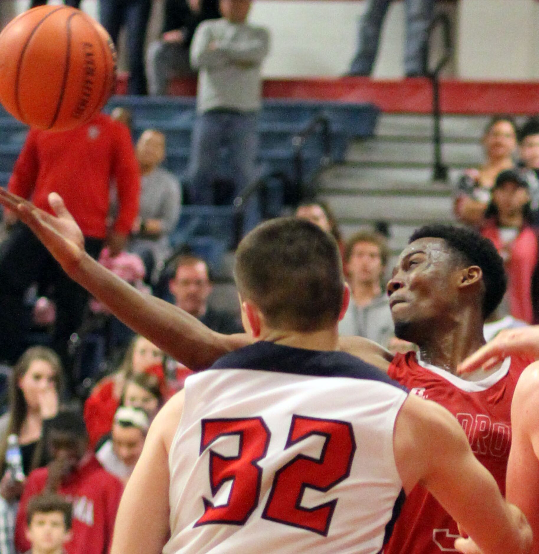 Woodrow Wilson's Hassan Thomas (3) reaches over Frisco Centennial forward John Robbins (32)...