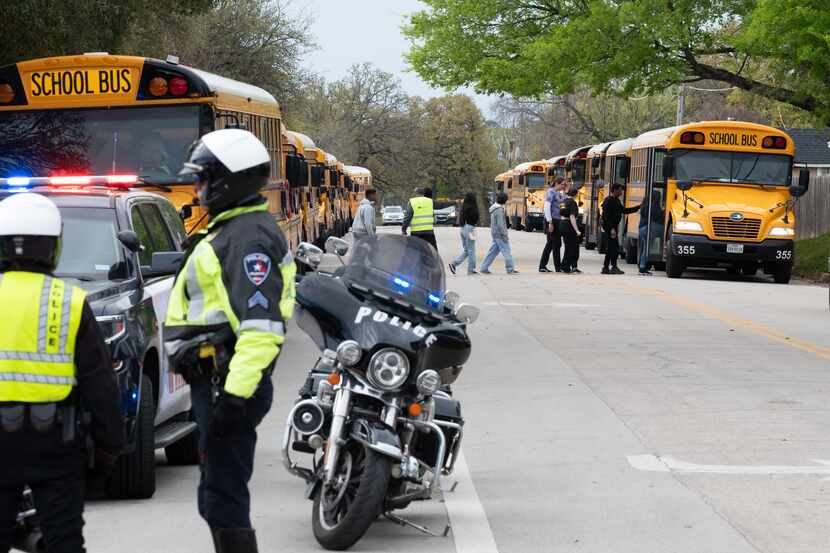 Arlington Police Officers block a street as Lamar High School students and faculty are...
