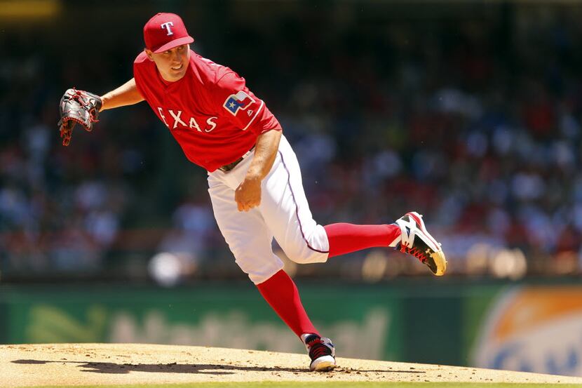 Texas Rangers starting pitcher Derek Holland (45) watches his first inning pitch against the...