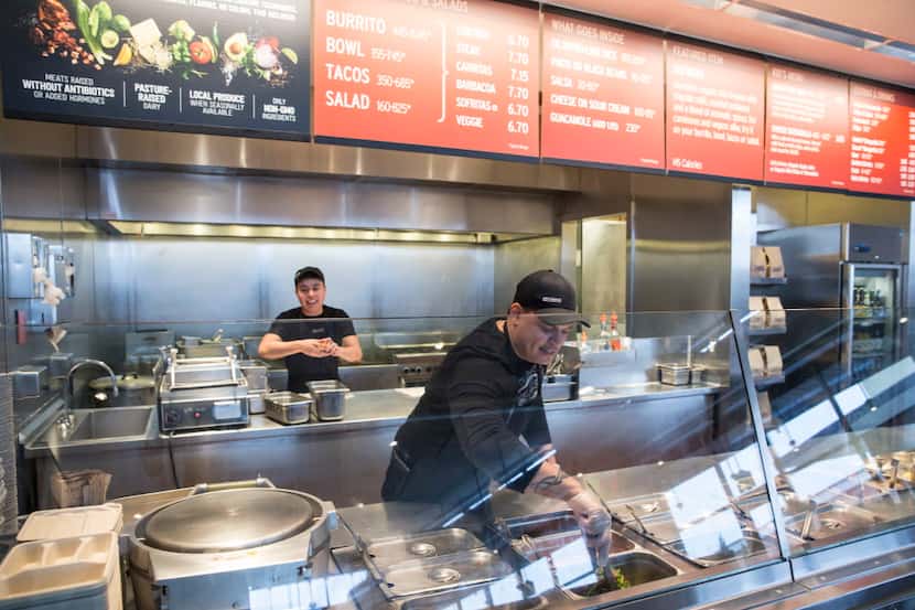 A Chipotle Mexican Grill employee prepares food on Tuesday Dec. 15, 2015, in Seattle....