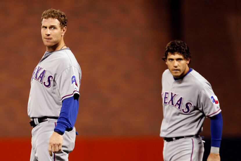 Texas Rangers Josh Hamilton (32) and Ian Kinsler (5) wait for their hat and gloves after...
