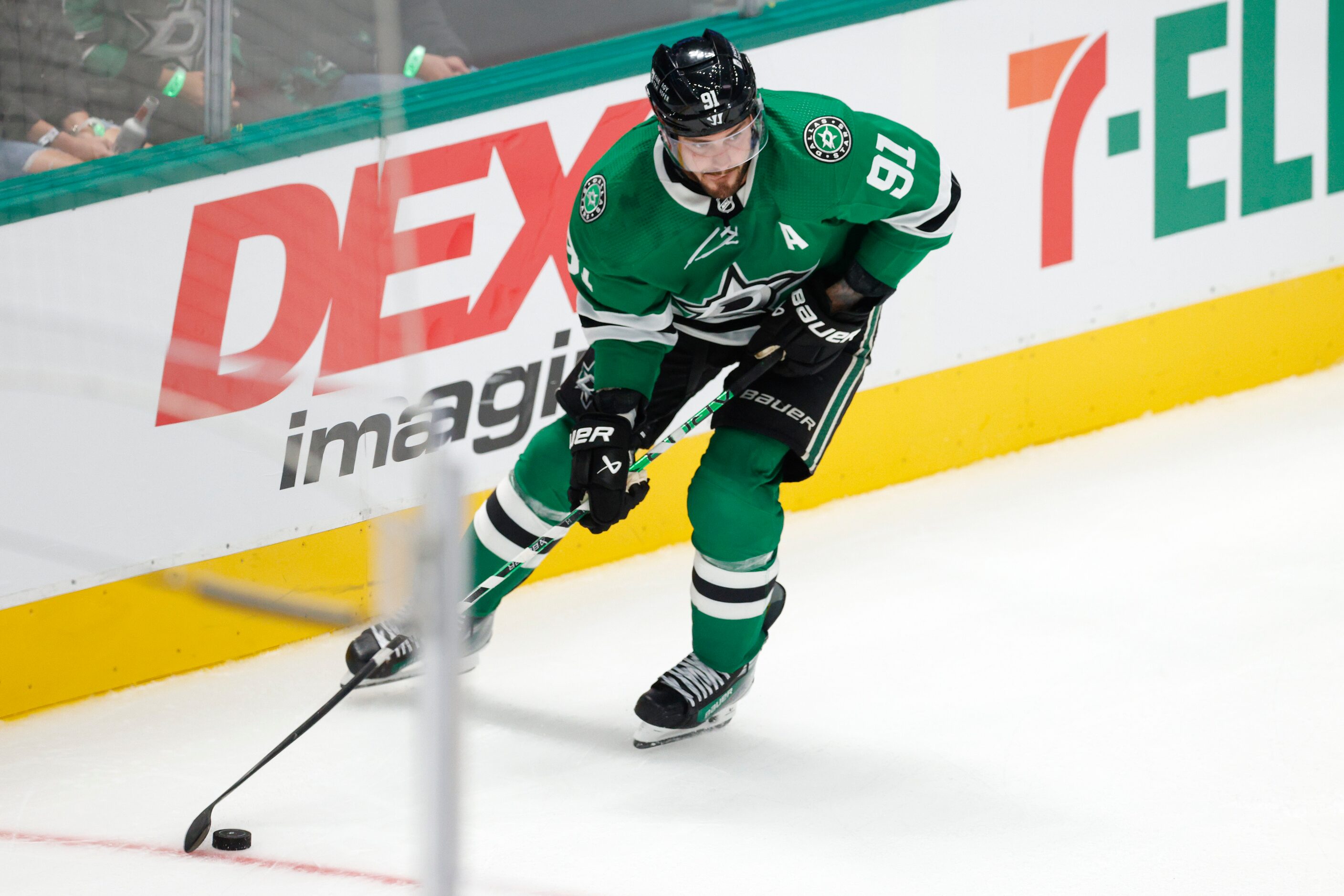 Dallas Stars center Tyler Seguin (91) skates behind the goal with the puck during the third...