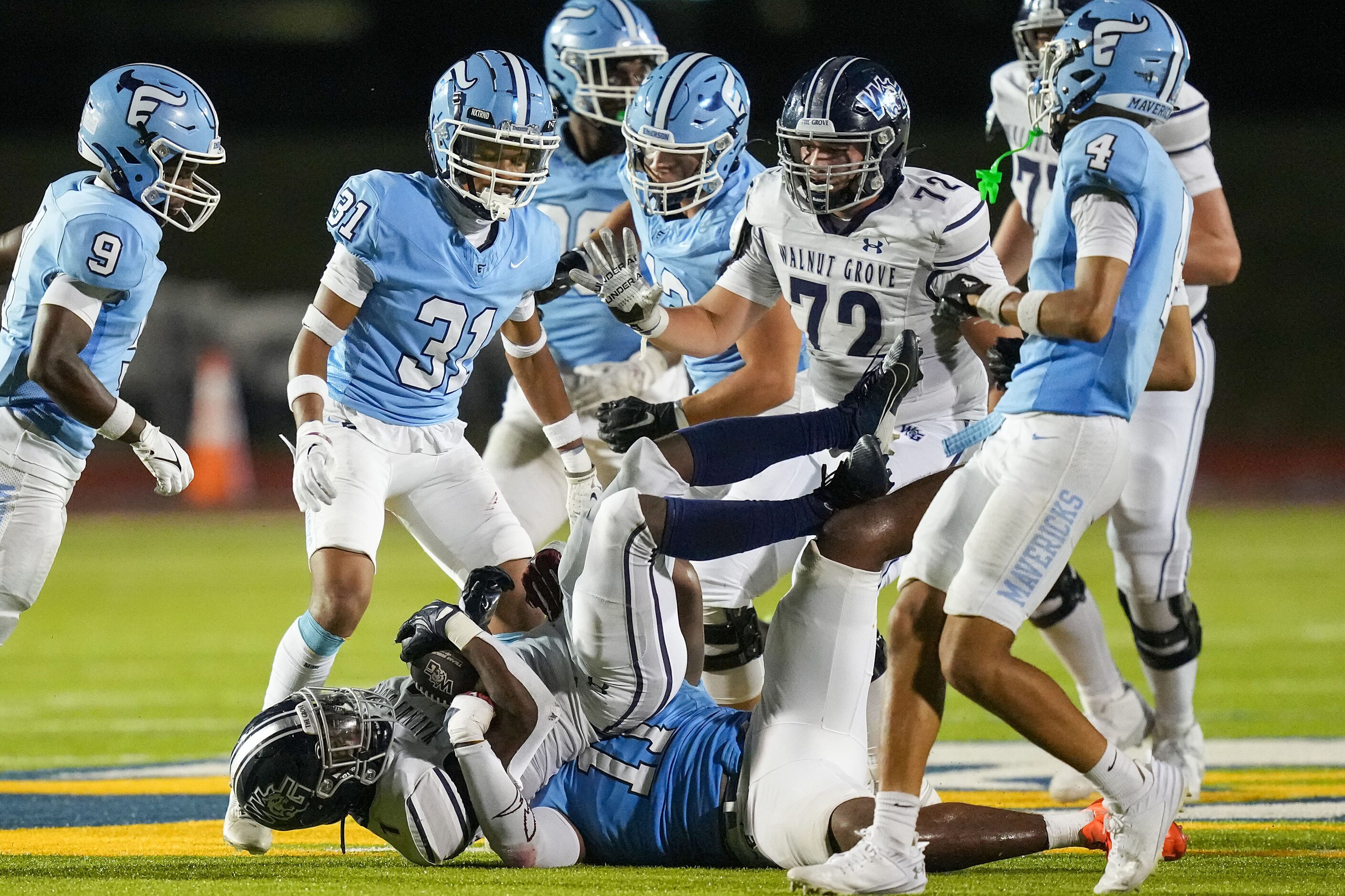 Prosper Walnut Grove running back Cameron Newton (1) is brought down by Frisco Emerson...